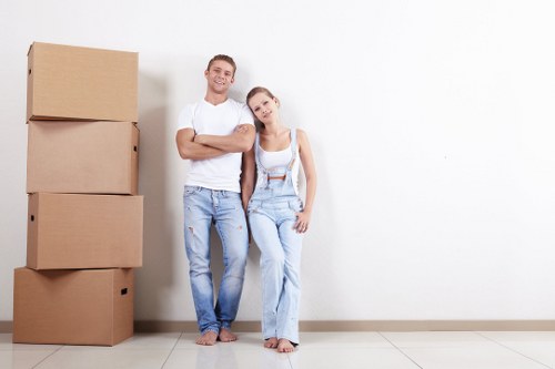 Professional packers carefully wrapping fragile items