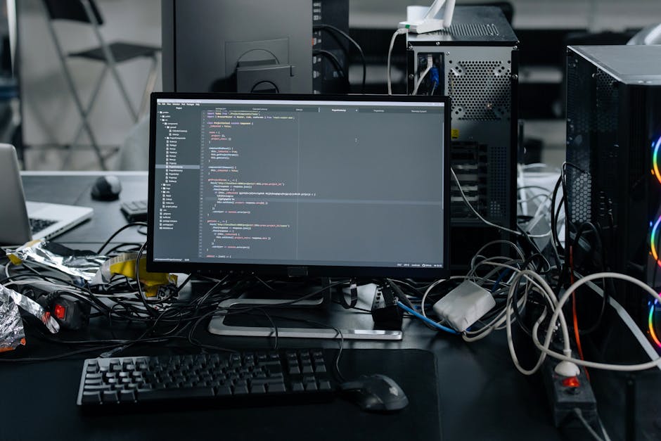 A computer screen displaying a closely cropped view of a digital code editor filled with multicolored programming code lines in red, green, blue, purple, and yellow, on a dark background. The code inc